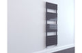 Tall narrow dark gray radiator against a white wall